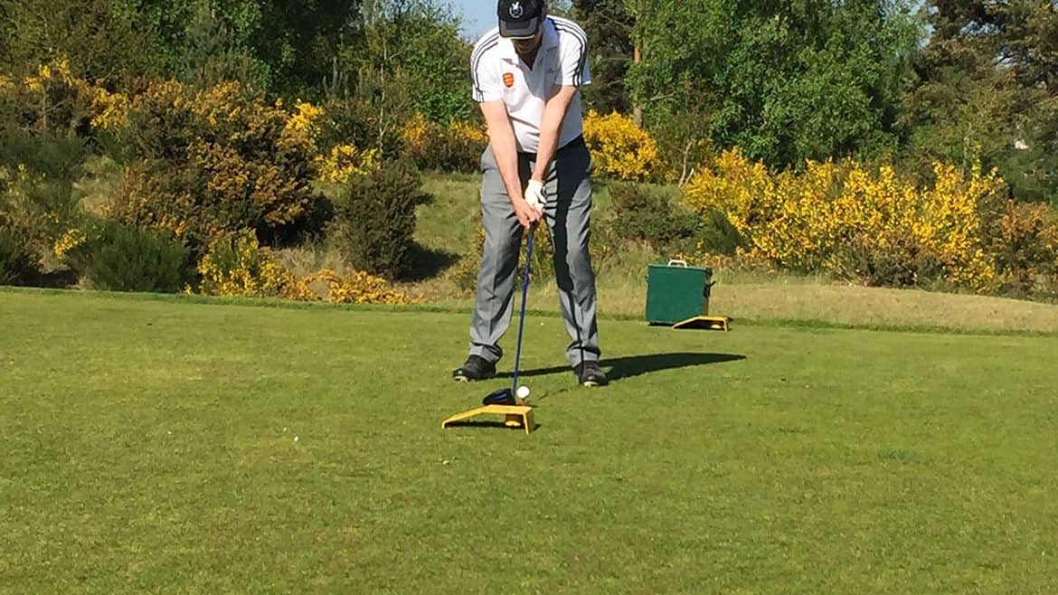 John playing golf on a sunny day