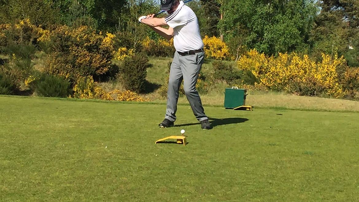 John playing golf on a sunny day